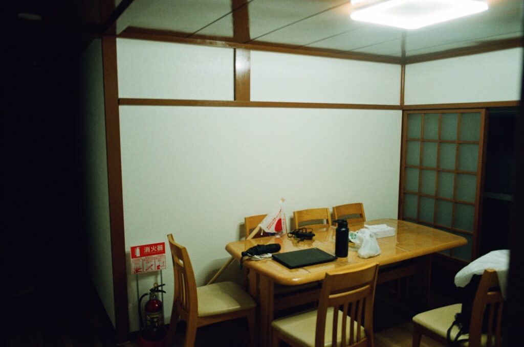 A dining table set with chairs in a room.