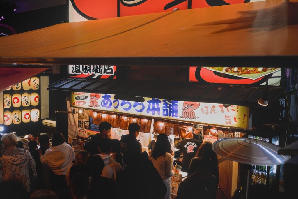 A group of people standing in front of a restaurant
