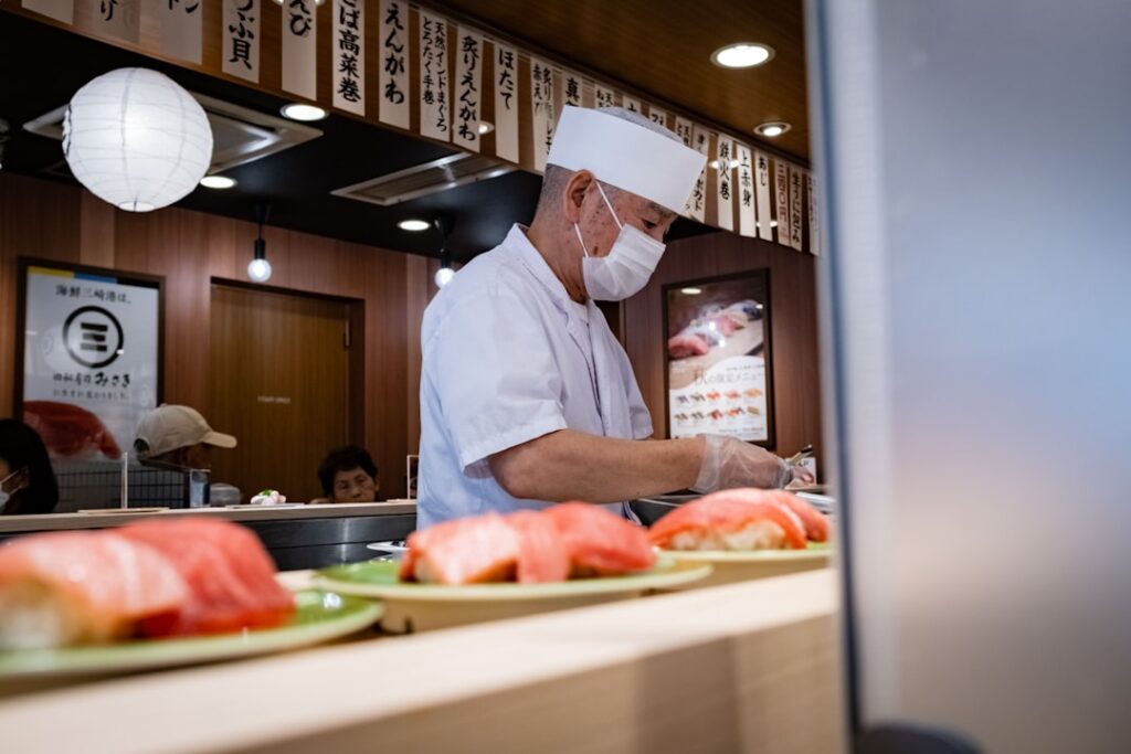 a chef preparing sushi in a restaurant