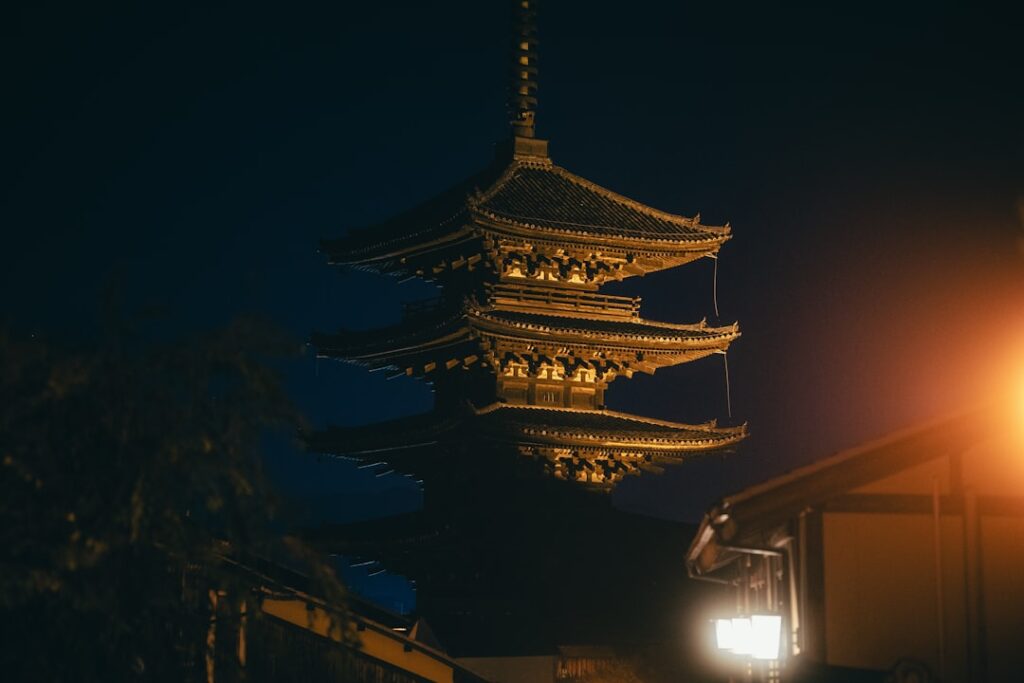 a tall tower lit up at night with a street light
