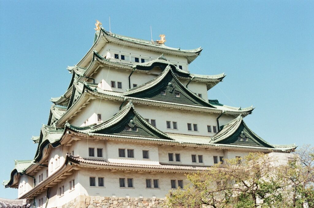 A traditional japanese castle against a clear blue sky.