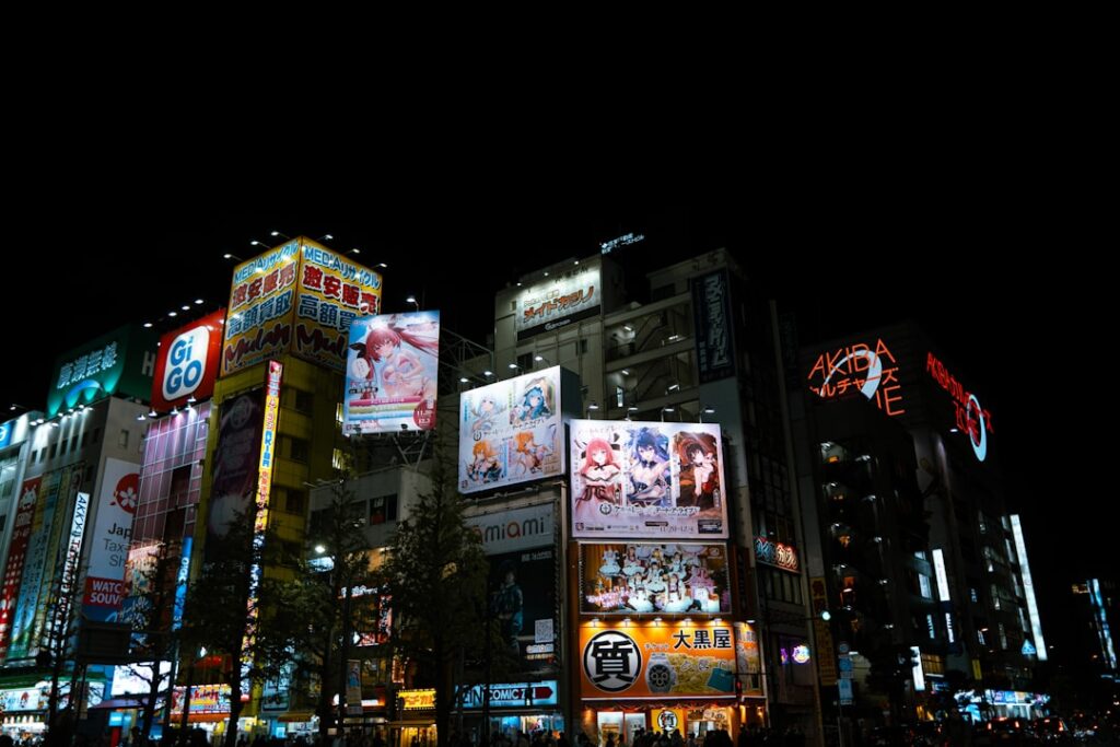 City buildings illuminated with bright advertisements at night